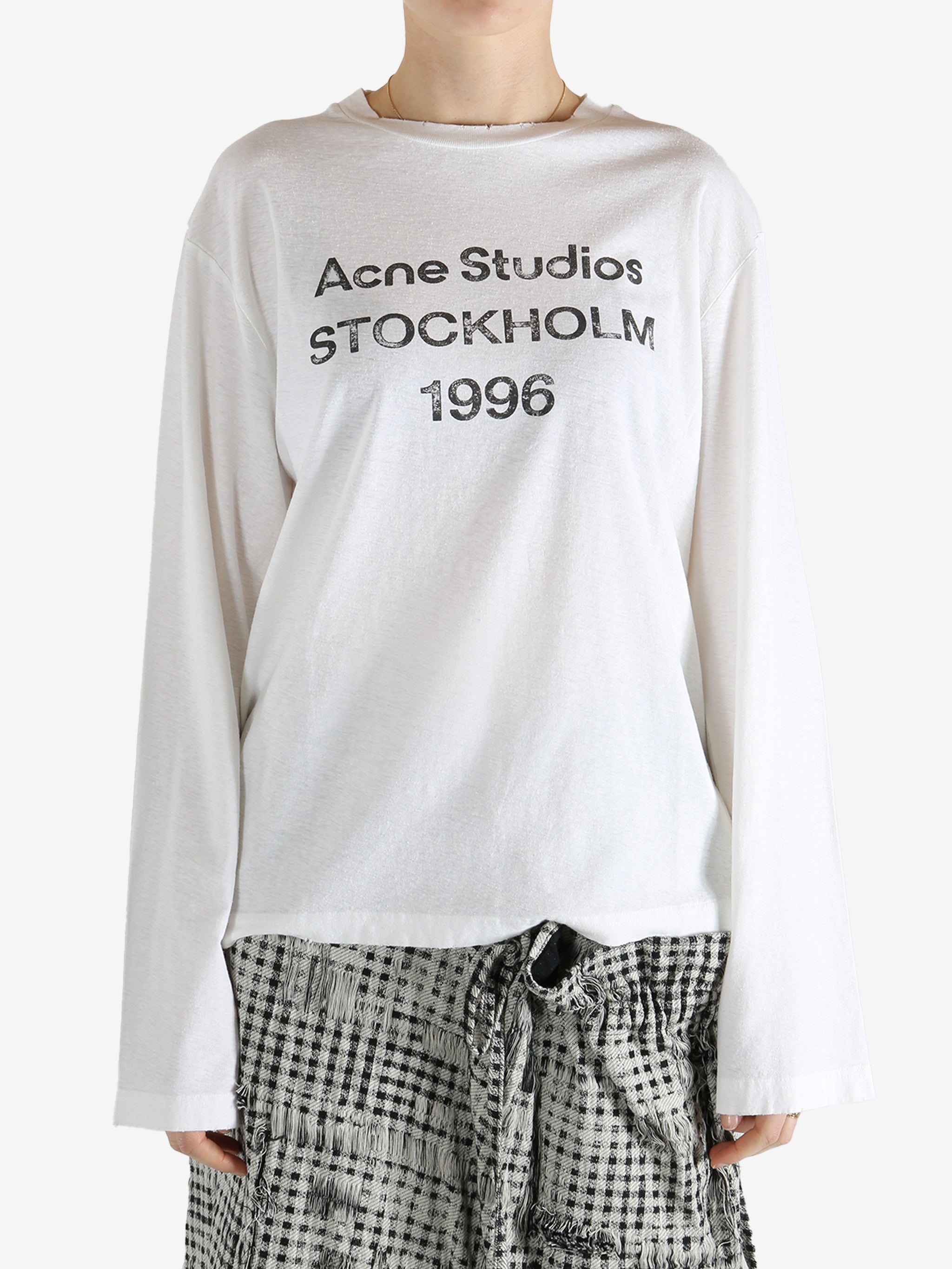 White t-shirt worn by a person, showing the t-shirt fit