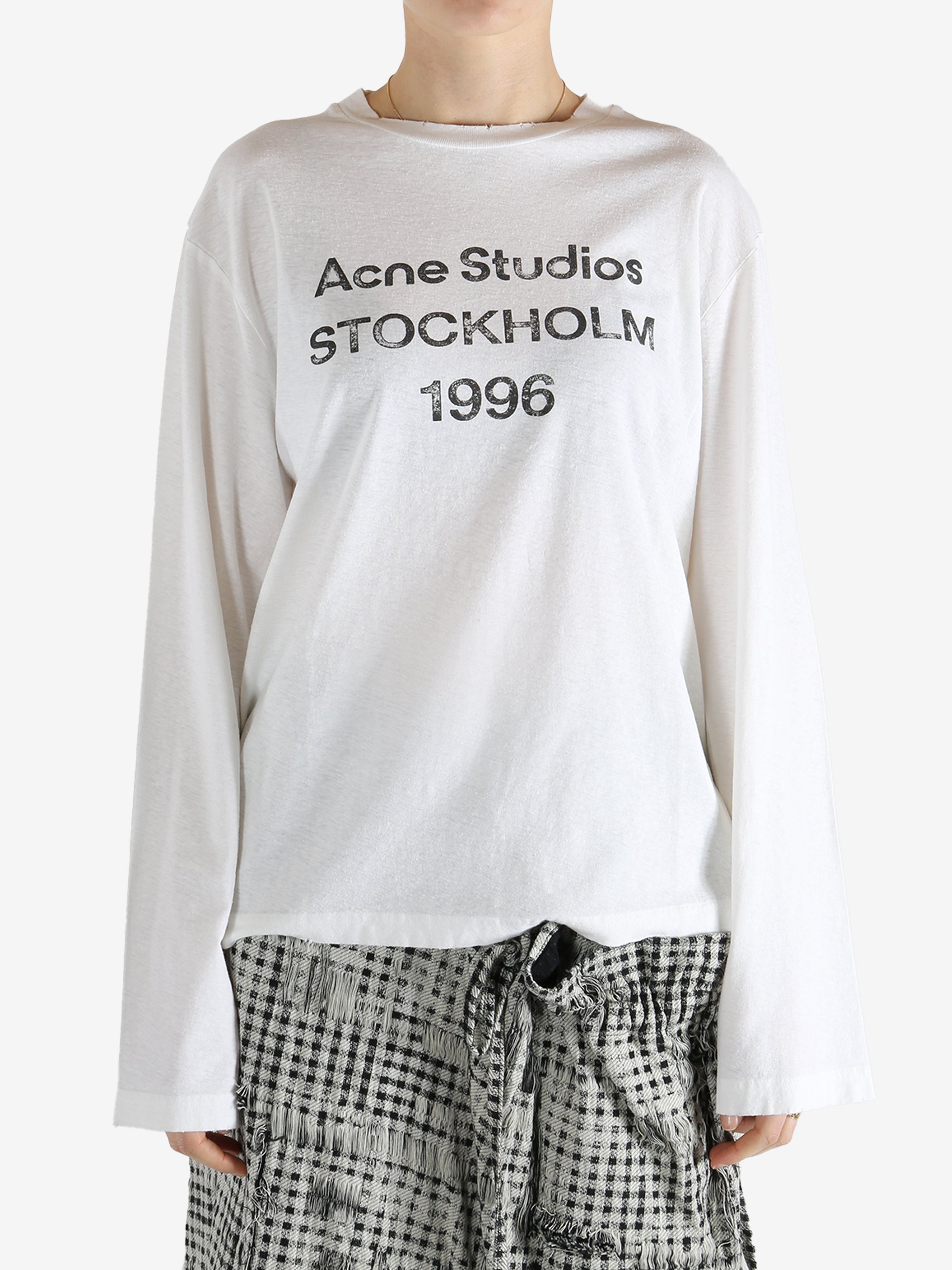 White t-shirt worn by a person, showing the t-shirt fit