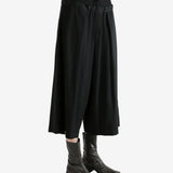 Black pants worn by a person, showing the pants fit