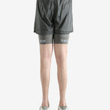 Grey shorts worn by a person, showing the shorts fit