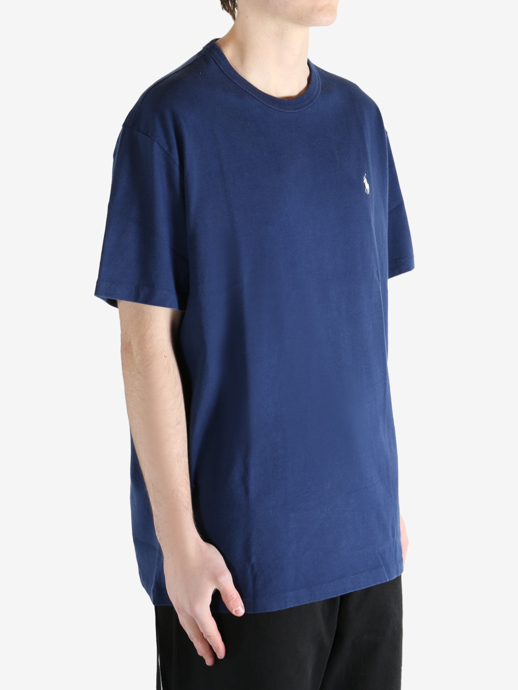 Navy blue t-shirt worn by a person, showing the shirt's fit