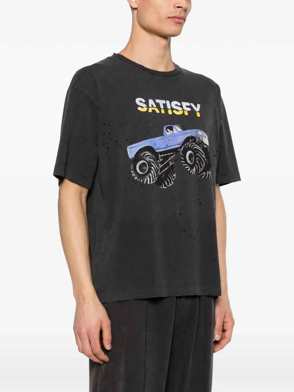 Black t-shirt worn by a person, showing the shirt's fit