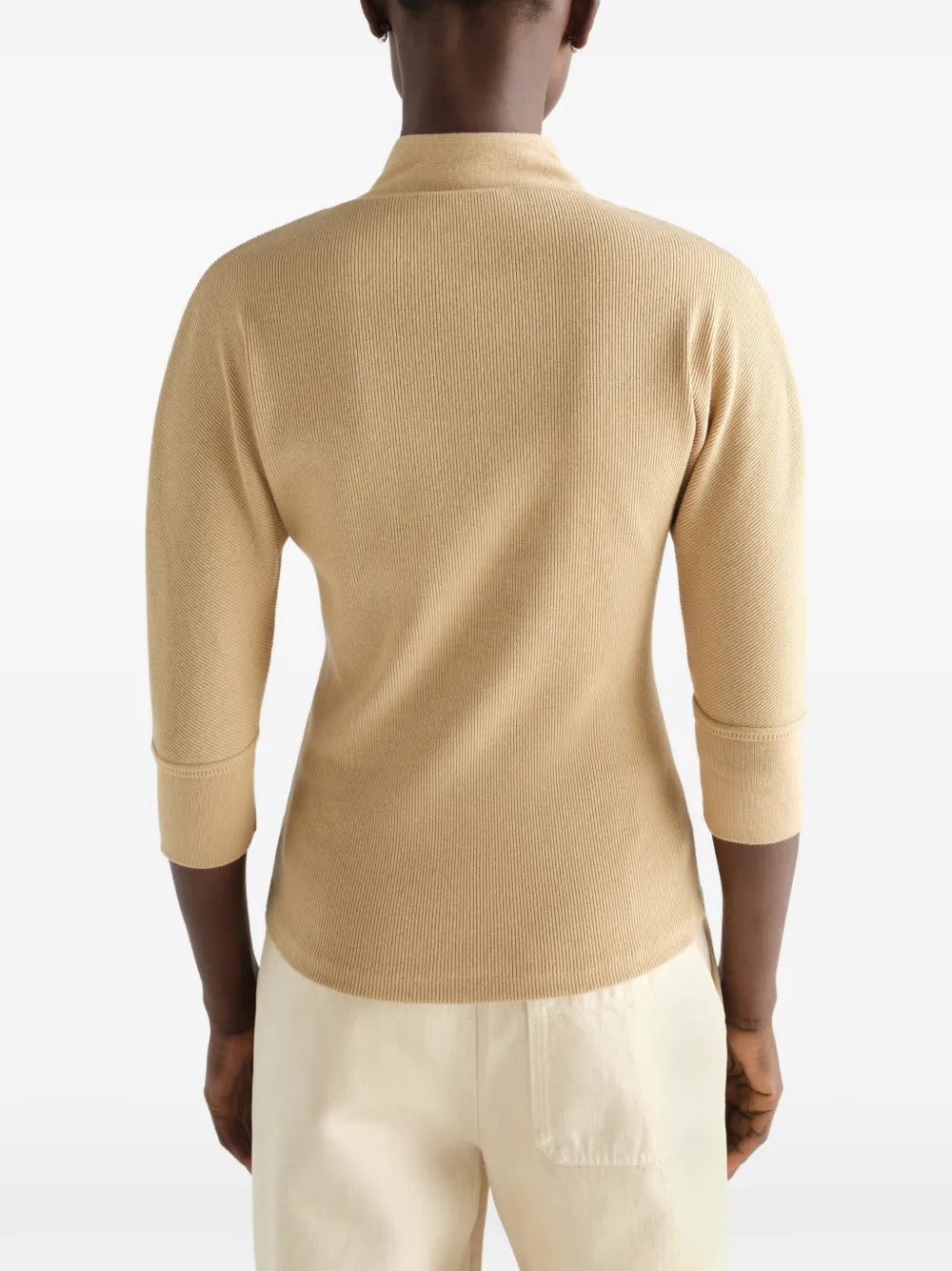 Tan shirt worn by a person, showing the shirt fit
