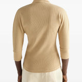 Tan shirt worn by a person, showing the shirt fit