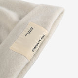 Close up of tan hats, showing texture of the wool fabric