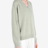 Green hoodie worn by a person, showing the hoodie fit