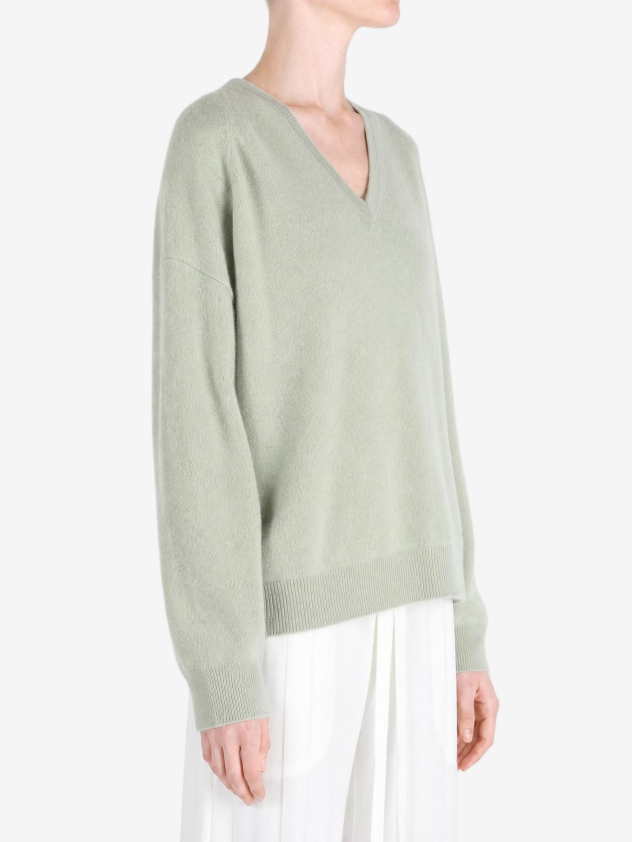Green hoodie worn by a person, showing the hoodie fit