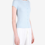 Blue knitwear worn by a person, showing the knitwear fit