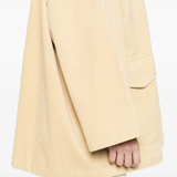 Close up of tan jacket, showing texture of the Cotton fabric