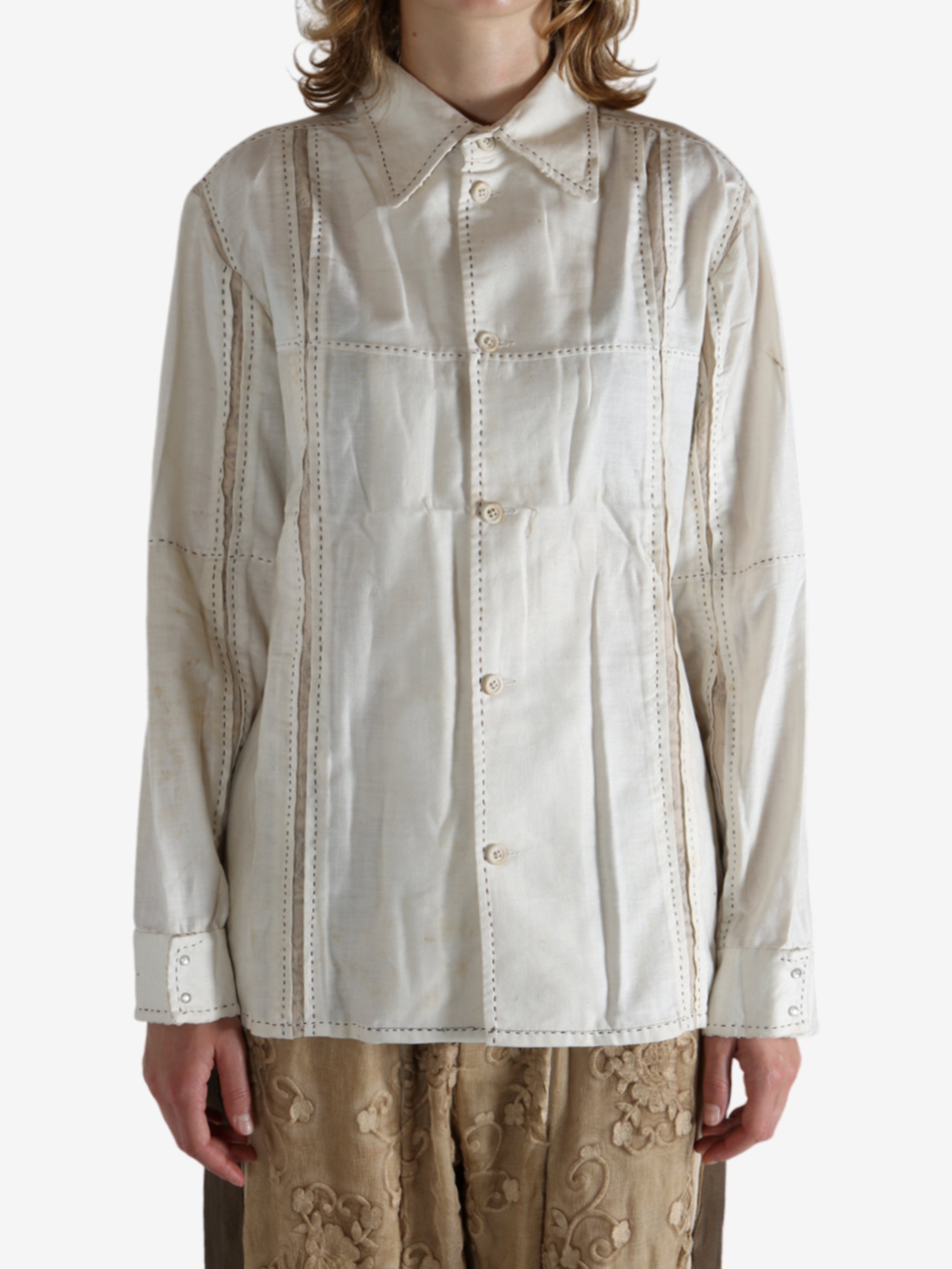 White shirt worn by a person, showing the shirt's fit