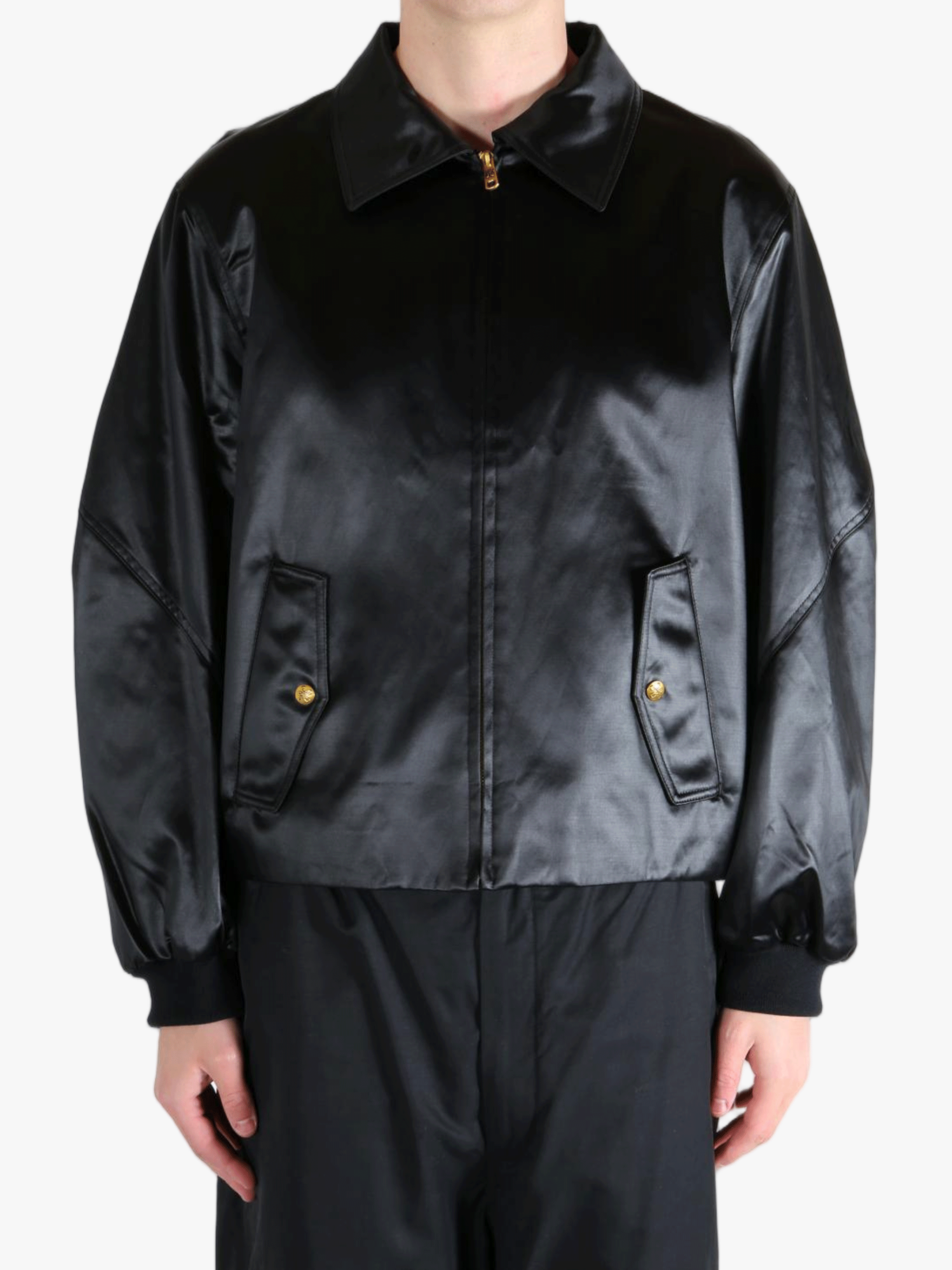 Black satin jacket worn by a person, showing the jacket fit