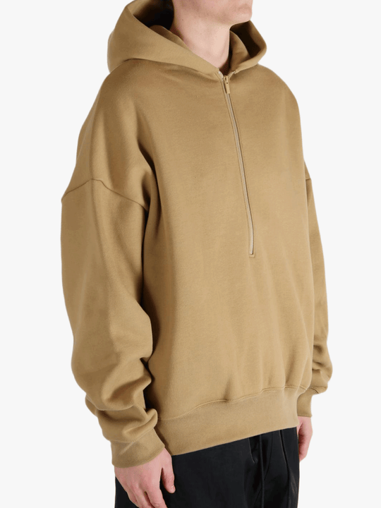 Brown hoodie worn by a person, showing the hoodie's fit