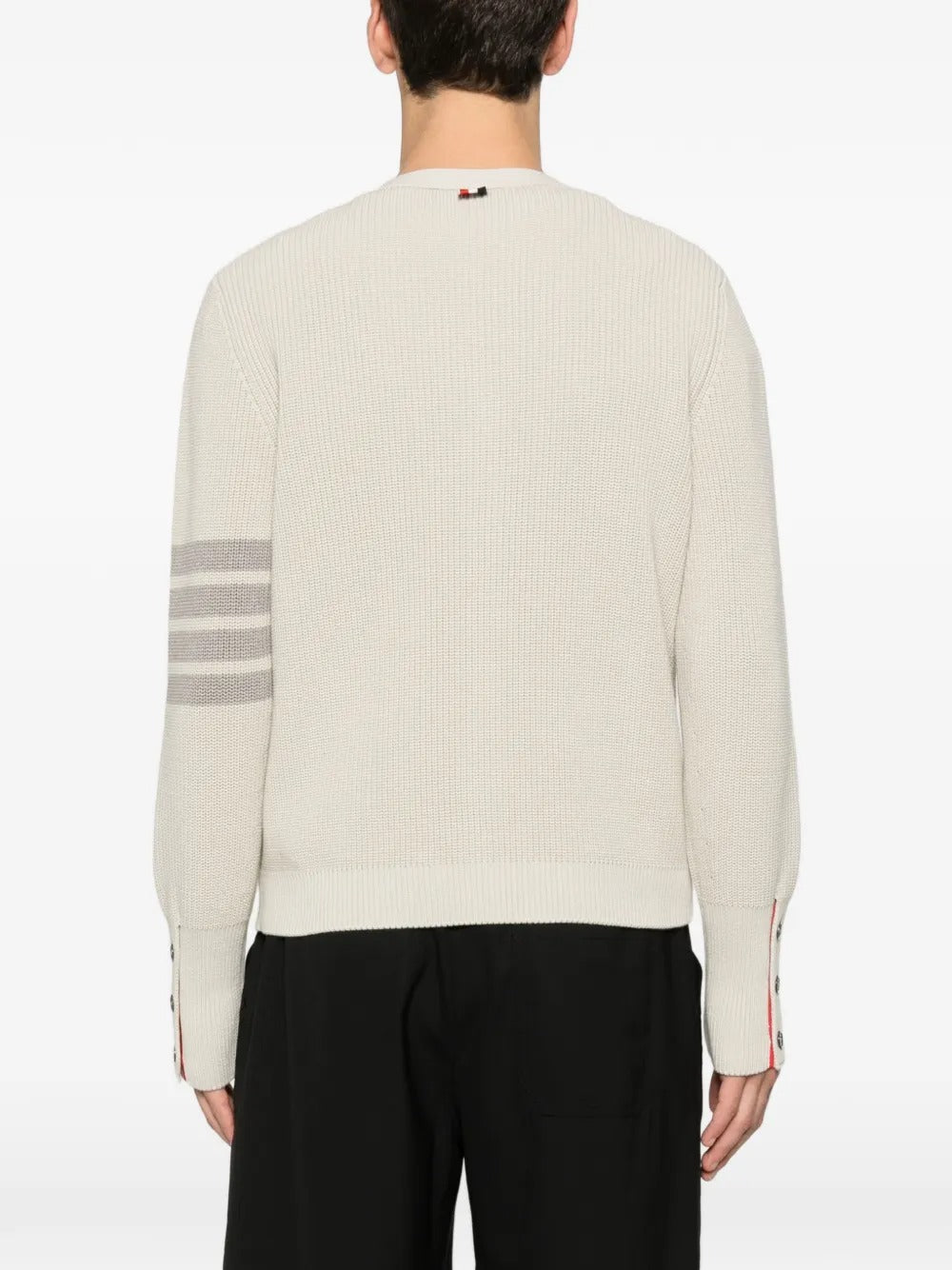 White cardigan worn by a person, showing the cardigan's fit