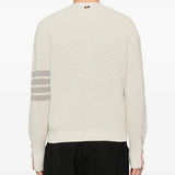 White cardigan worn by a person, showing the cardigan's fit