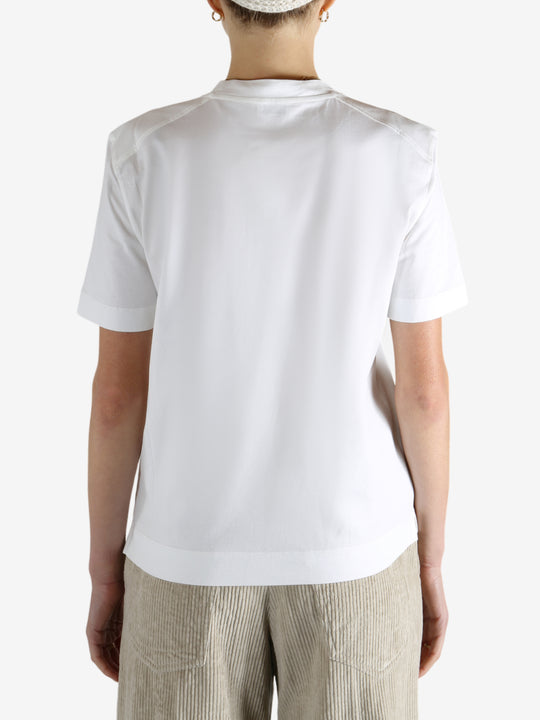 White t-shirt worn by a person, showing the t-shirt fit