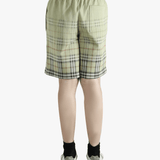 Green shorts worn by a person, showing the shorts fit