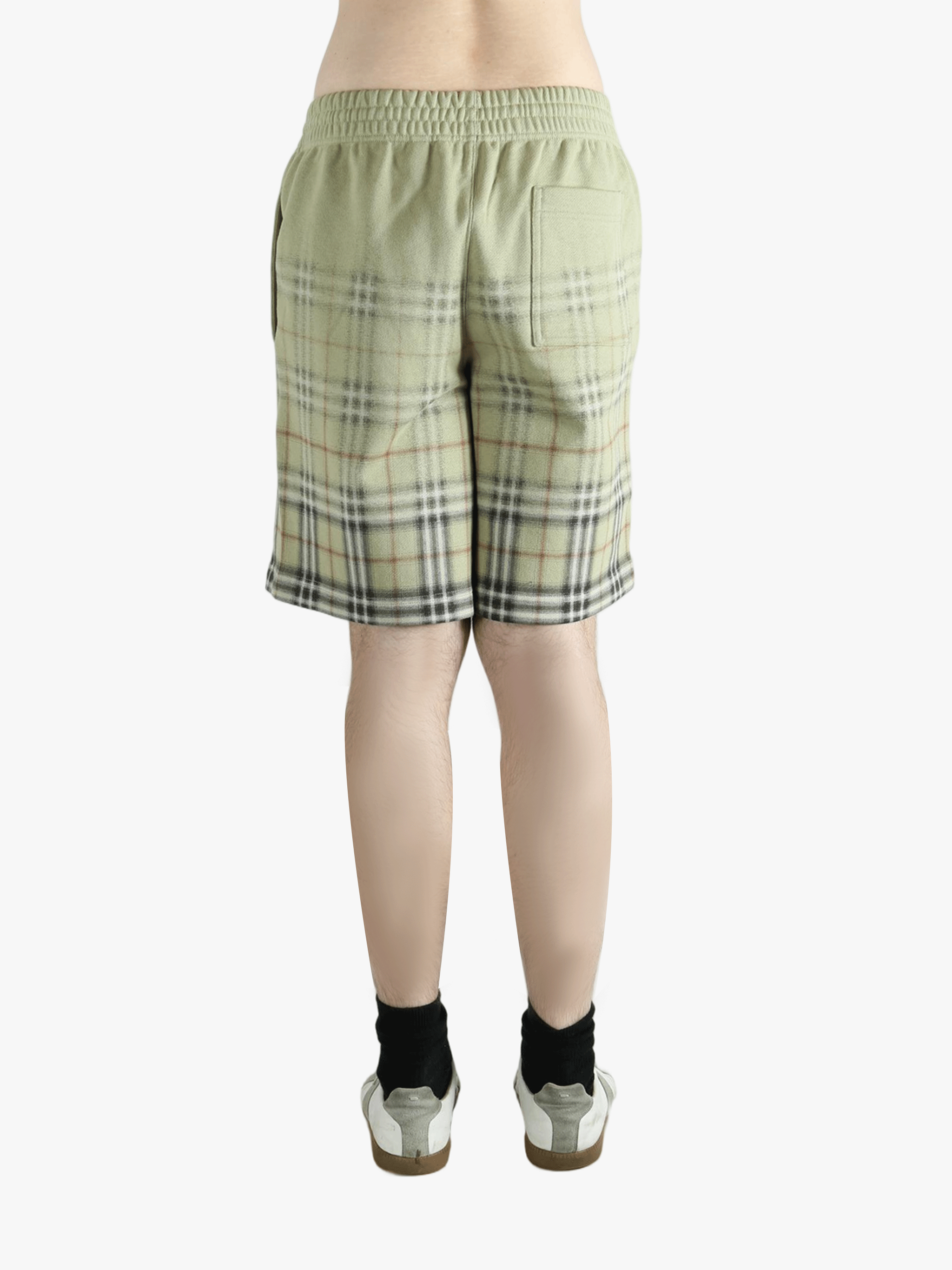 Green shorts worn by a person, showing the shorts fit