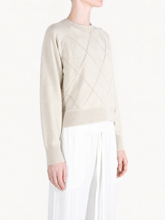 Tan knitwear worn by a person, showing the knitwear fit