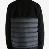 Black jackets worn by a person, showing the jackets fit