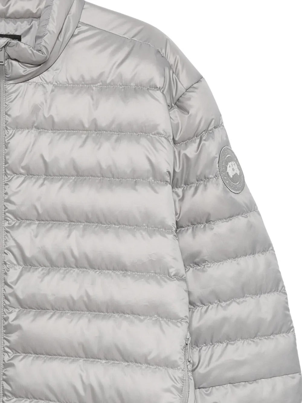 Close up of grey jacket, showing texture of the polyester fabric
