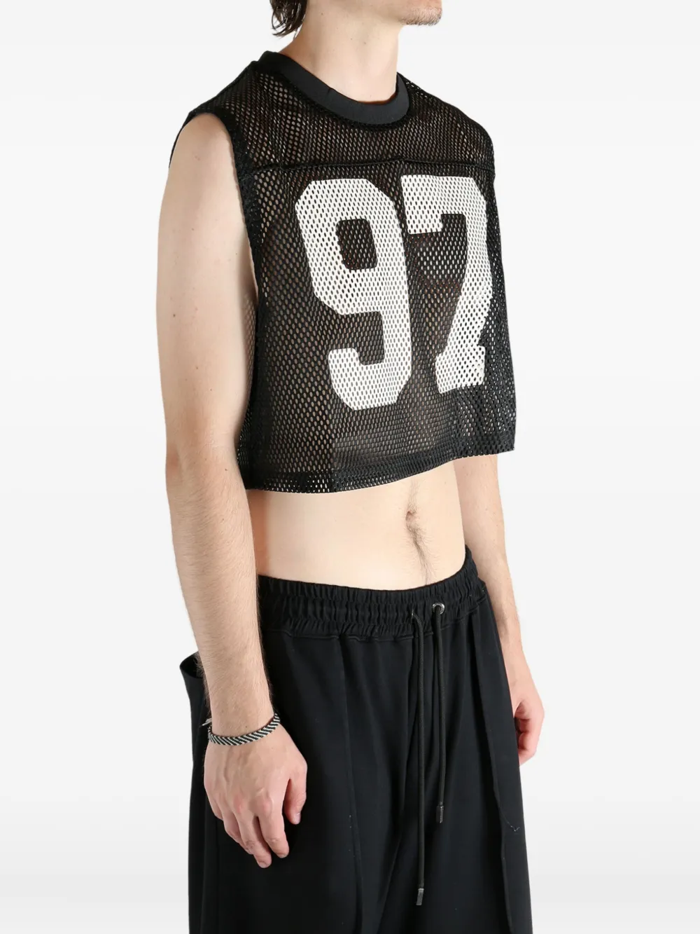 Black top worn by a person, showing the top's fit