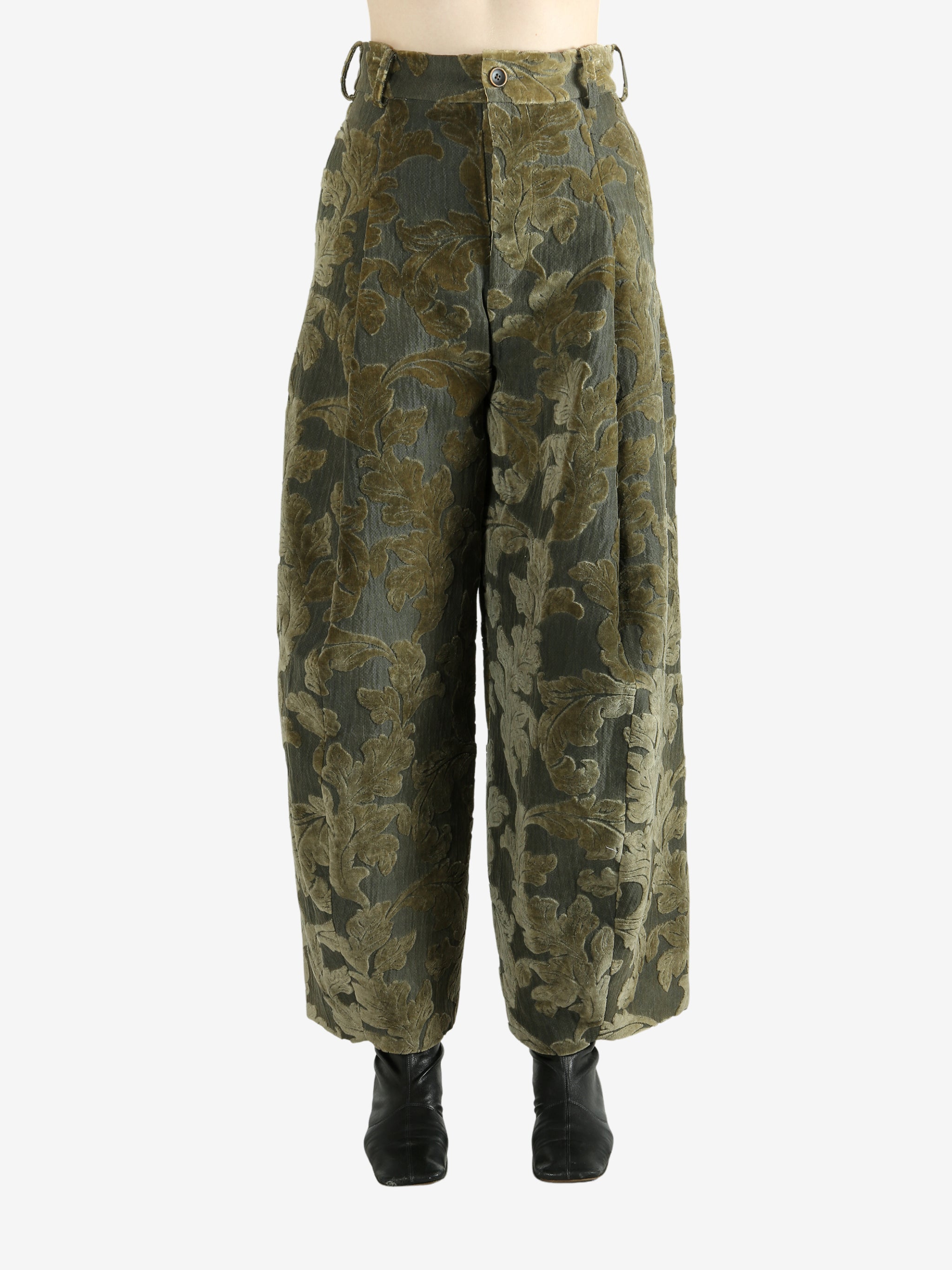 Green pants worn by a person, showing the pants' fit