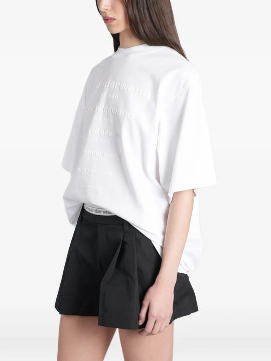White t-shirt worn by a person, showing the t-shirt fit