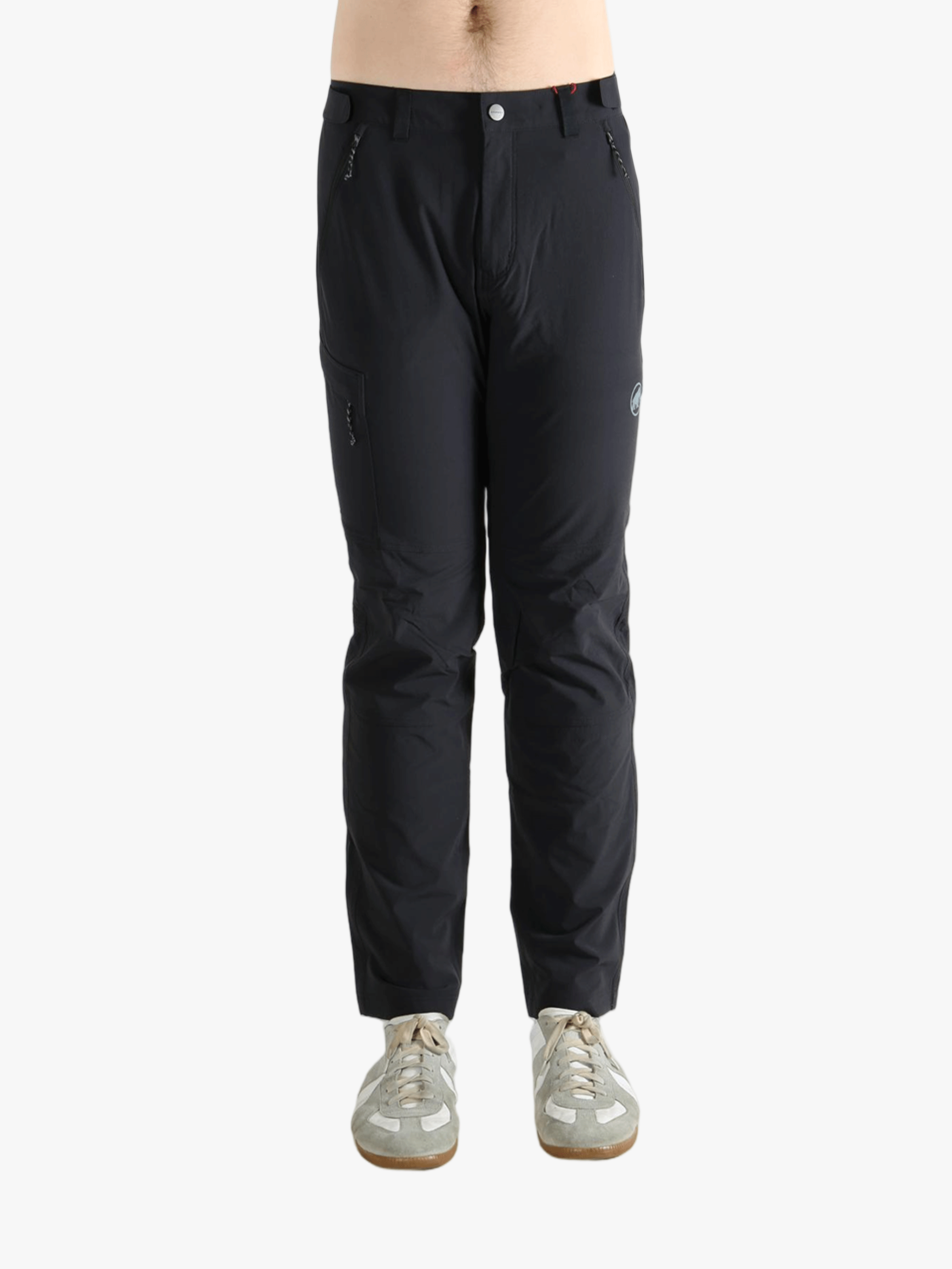 Black pants worn by a person, showing the pants's fit