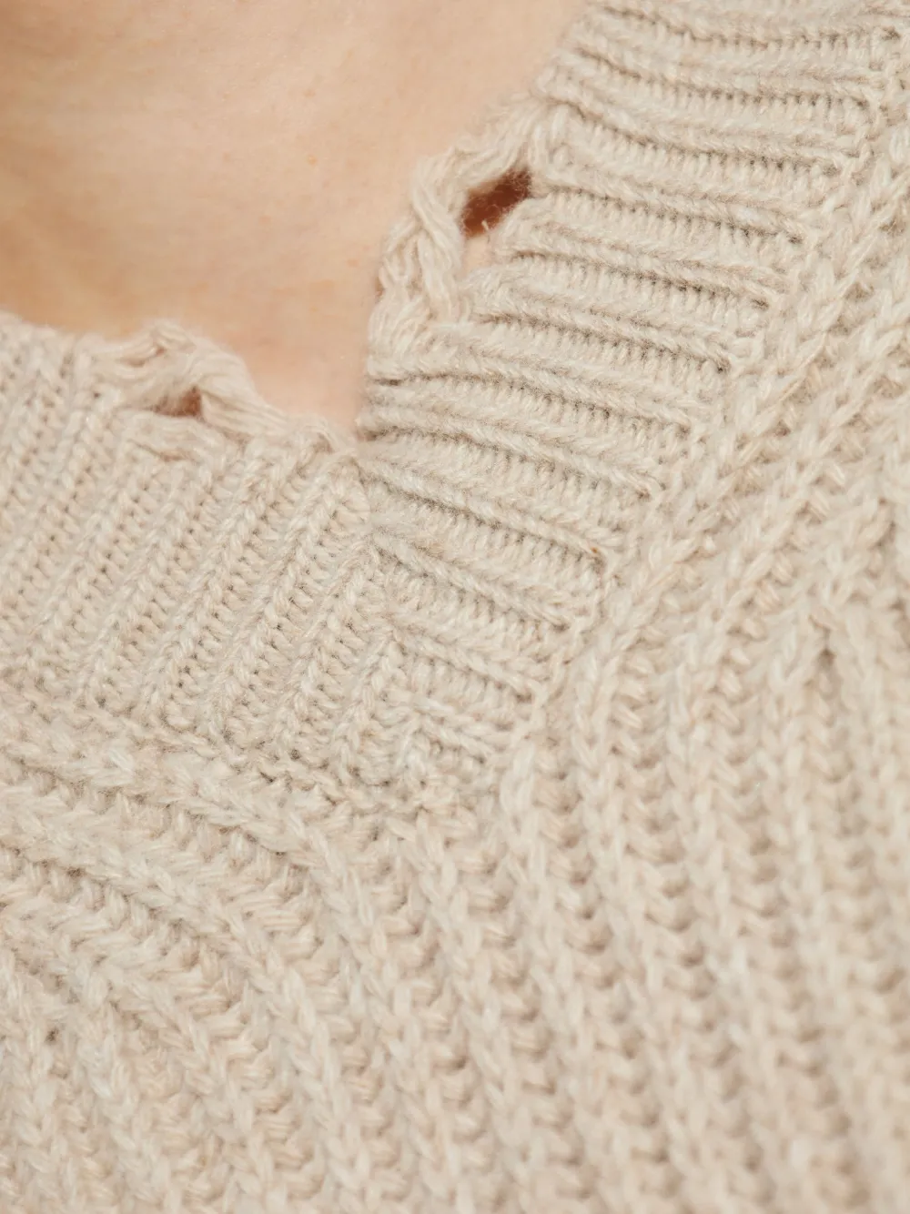Close up of the tan sweater, showing texture of the wool fabric