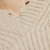 Close up of the tan sweater, showing texture of the wool fabric