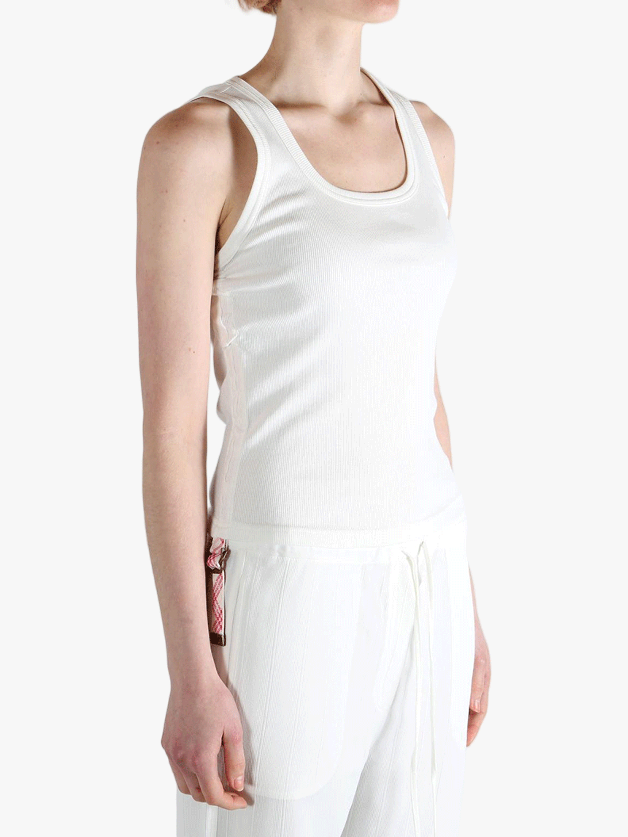 White top worn by a person, showing the top's fit