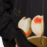 Black shirt worn by a person, showing the shirt fit