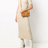 Brown bag carried by a person, showing the bag's fit