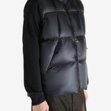 Black vest worn by a person, showing the vest  fit