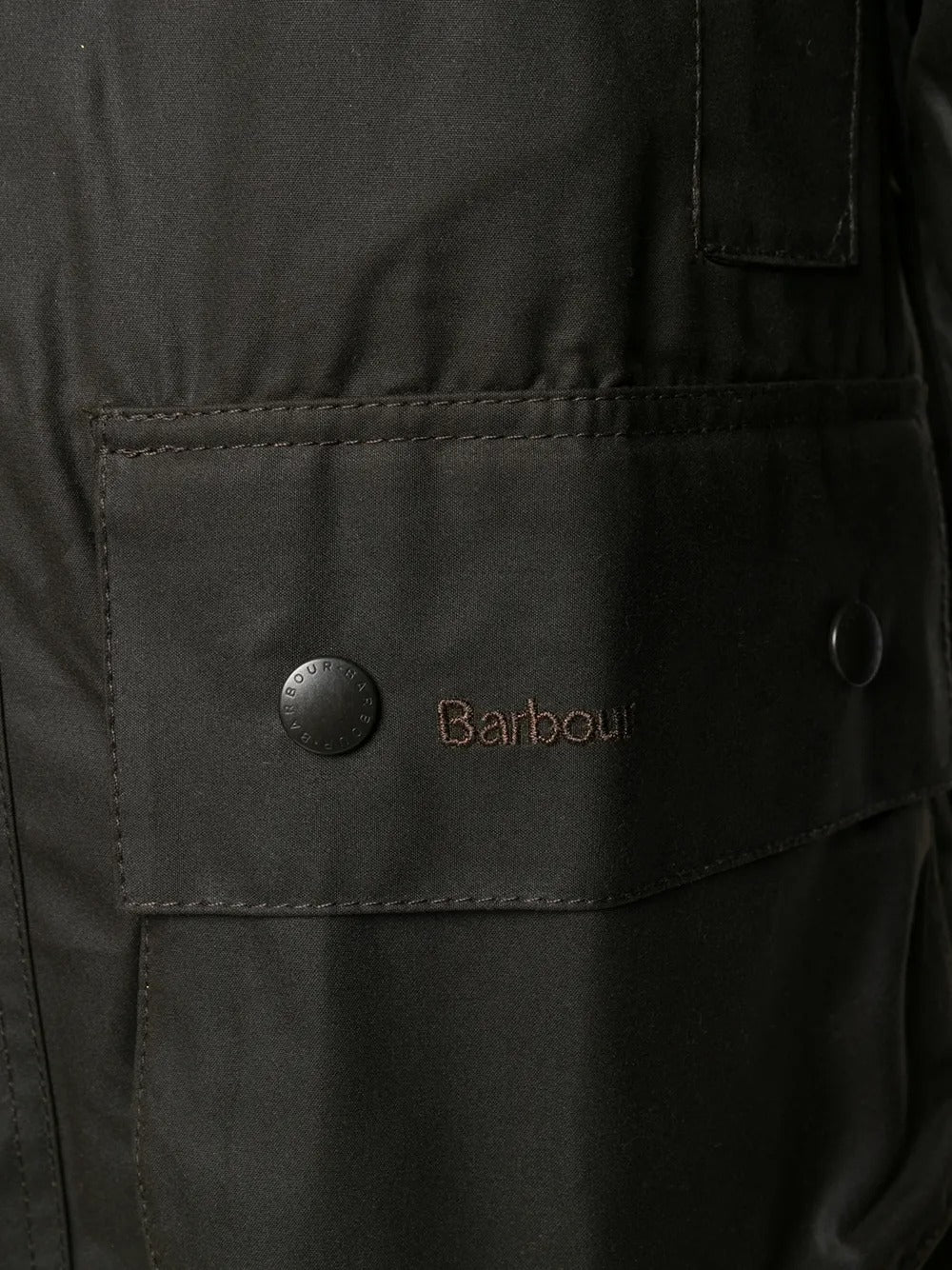 Close up of the brown jacket, showing texture of the cotton fabric