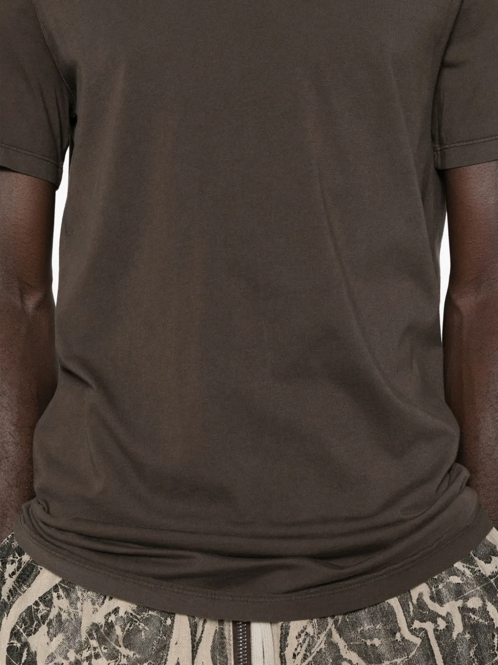 Close up of the brown t-shirt, showing texture of the cotton fabric