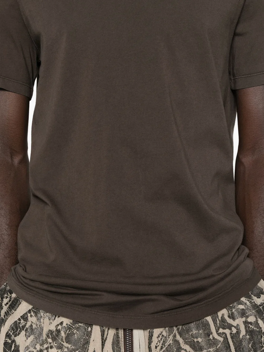 Close up of the brown t-shirt, showing texture of the cotton fabric