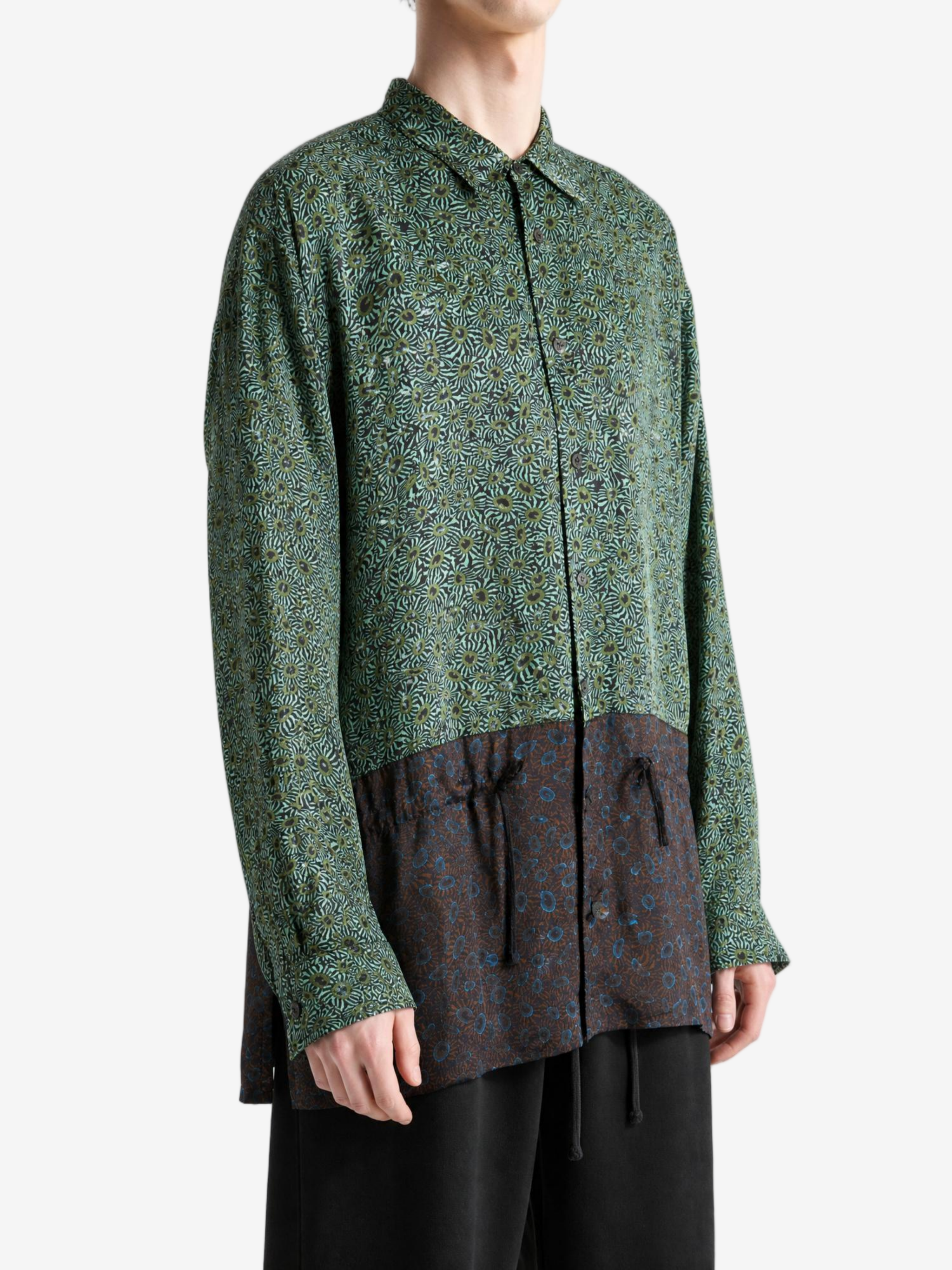 Green shirt worn by a person, showing the shirt fit