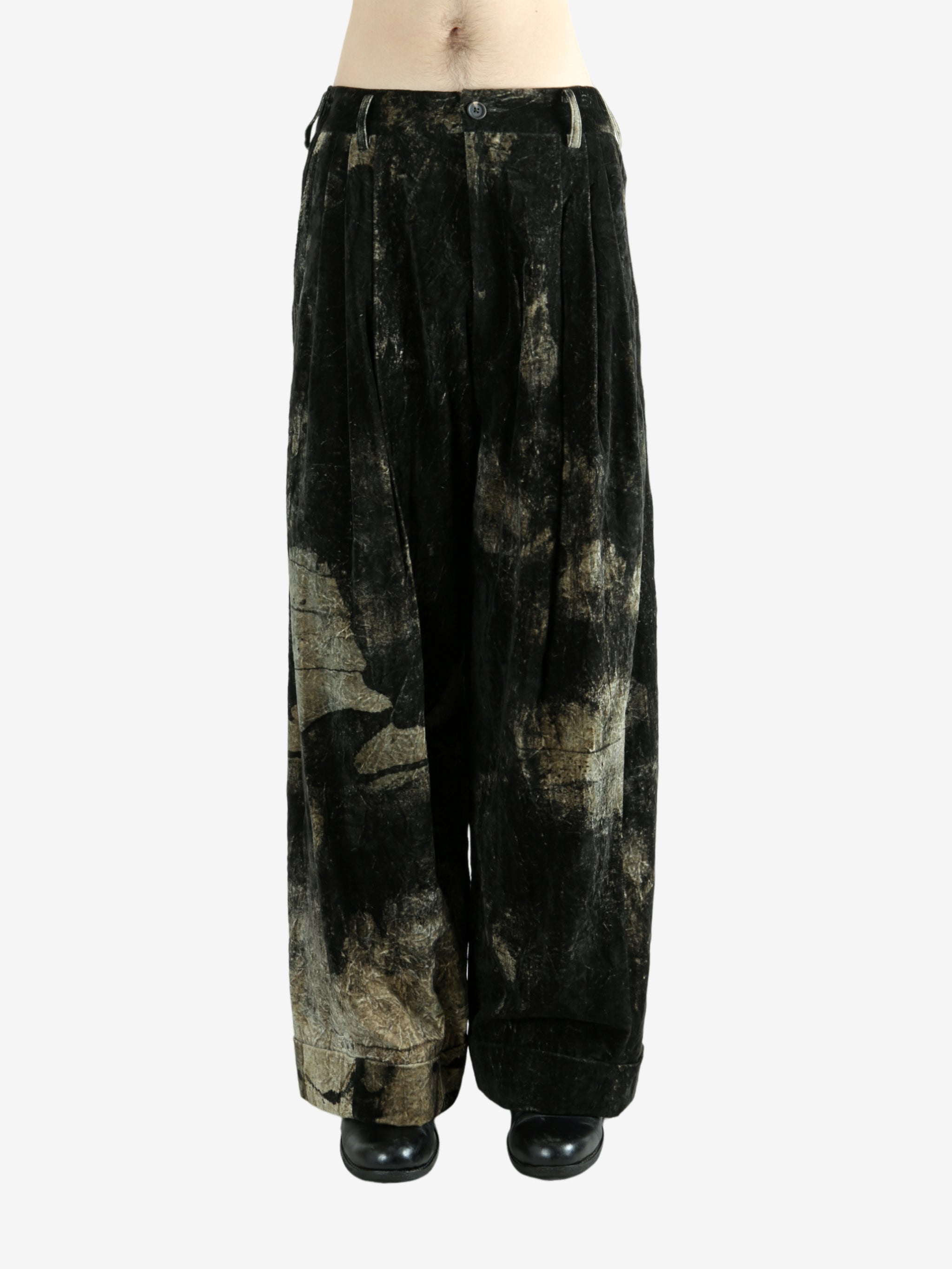 Black pants worn by a person, showing the pants fit