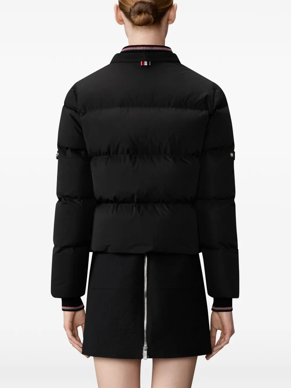 Black jacket worn by a person, showing the jacket fit