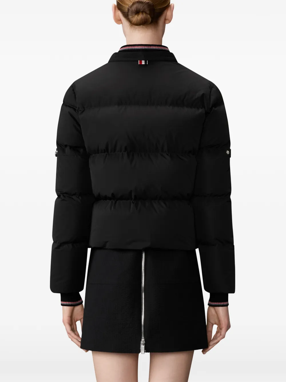 Black jacket worn by a person, showing the jacket fit