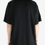 Black t-shirt worn by a person, showing the shirt's fit