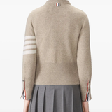 tan knitwear worn by a person, showing the knitwear fit