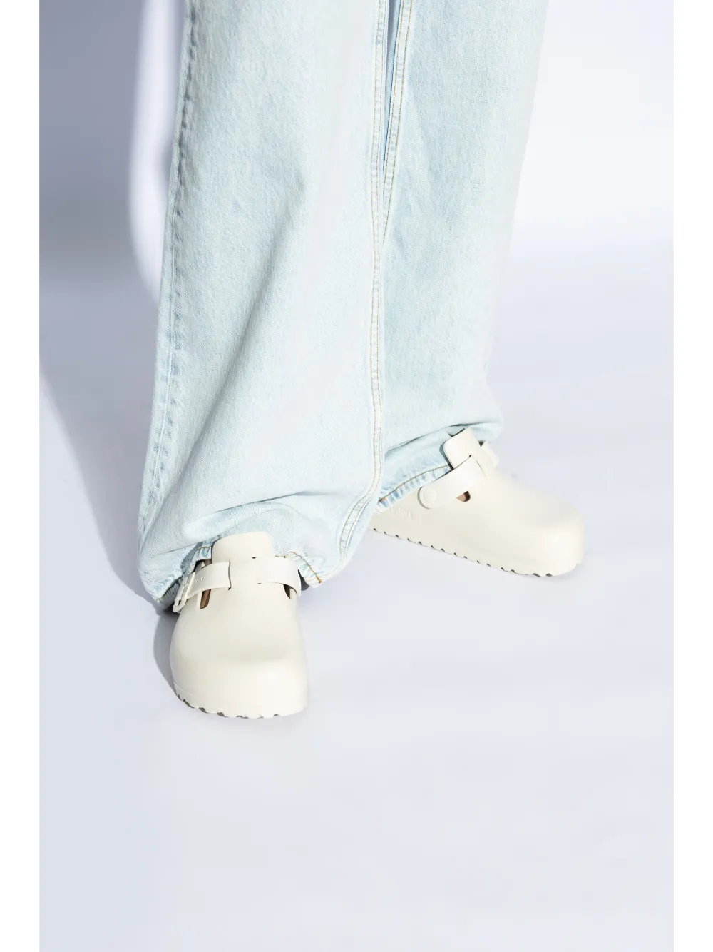 White sandals worn by a person, showing the sandals fit