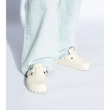 White sandals worn by a person, showing the sandals fit