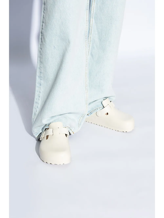 White sandals worn by a person, showing the sandals fit