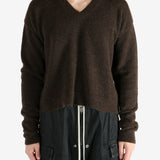 Brown knitwear worn by a person, showing the knitwear's fit