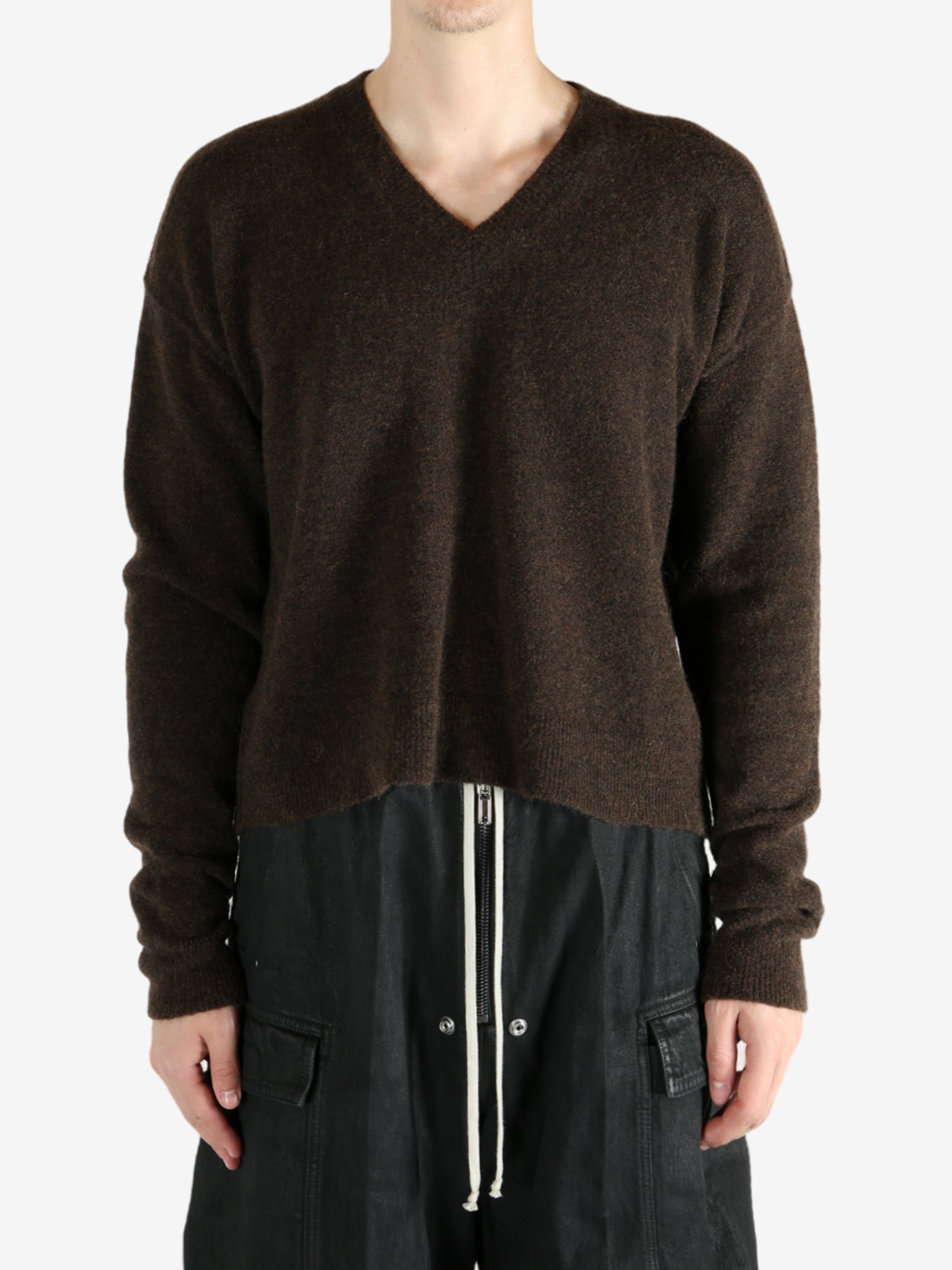 Brown knitwear worn by a person, showing the knitwear's fit