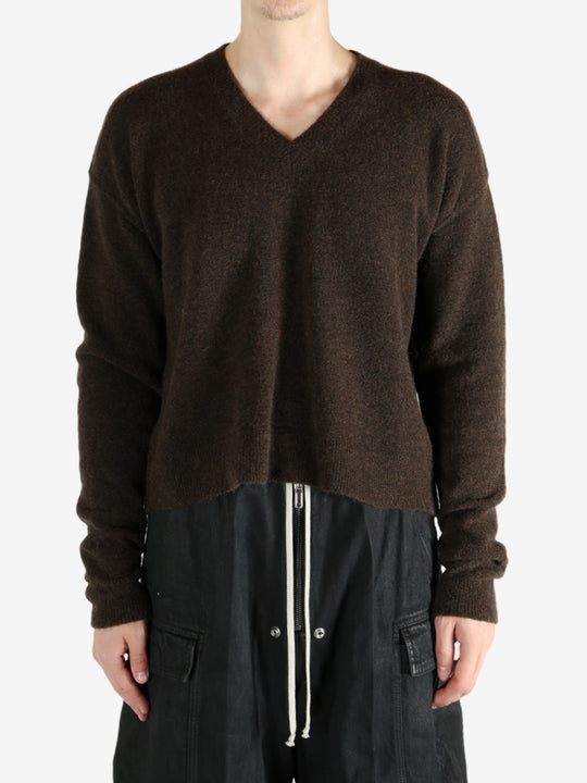 Brown knitwear worn by a person, showing the knitwear's fit