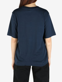 Navy tee worn by a person, showing the tee's fit